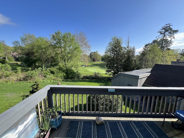 wooden deck with a yard and view of wooded area