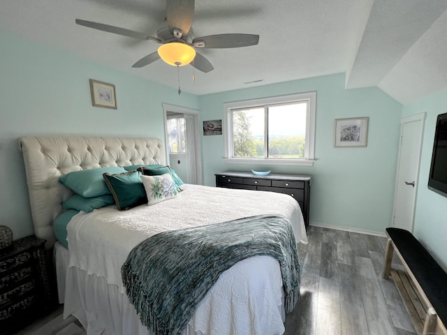 bedroom with wood finished floors, a ceiling fan, and baseboards