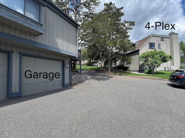view of side of home with an attached garage
