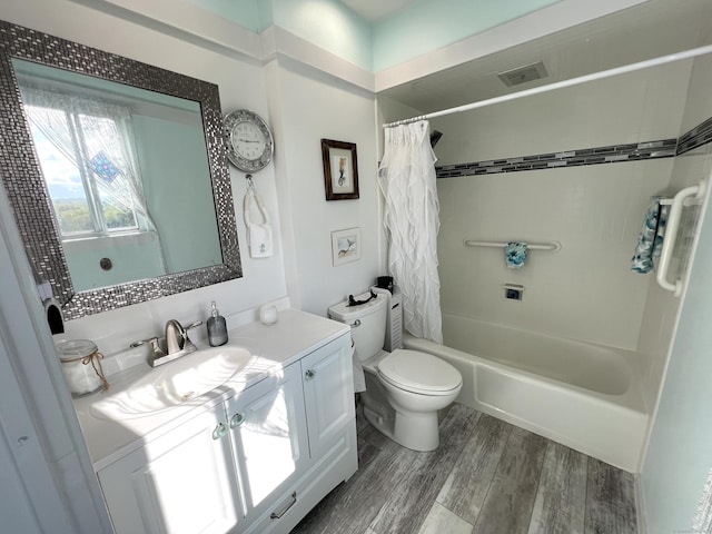 full bathroom featuring wood finished floors, toilet, shower / tub combo, and vanity