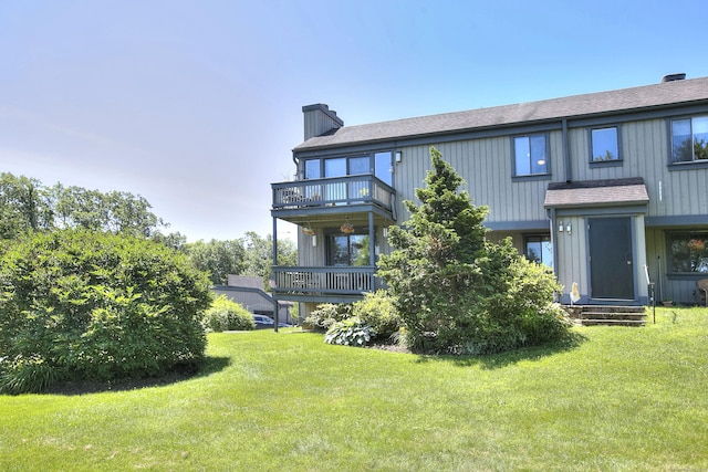 270 Heritage Vlg Unit D, Southbury, CT 06488 - rear view of house featuring a chimney, a lawn, a balcony, and a shingled roof