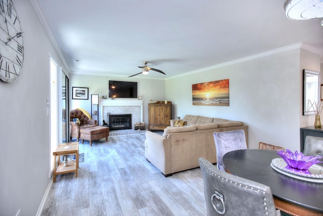 270 Heritage Vlg Unit D, Southbury, CT 06488 - living area featuring crown molding, light wood-style floors, a ceiling fan, and a brick fireplace