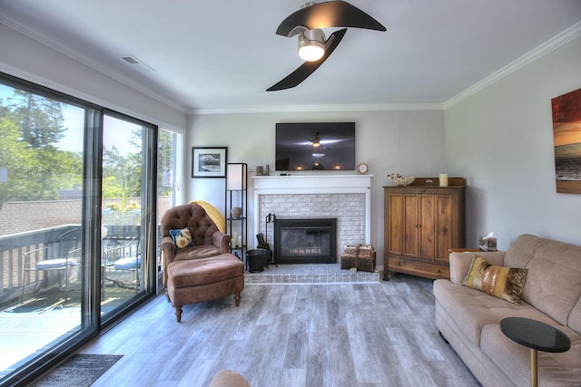 270 Heritage Vlg Unit D, Southbury, CT 06488 - living room featuring crown molding, light wood finished floors, a ceiling fan, and a fireplace