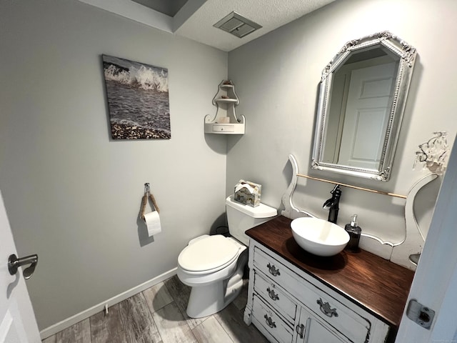 270 Heritage Vlg Unit D, Southbury, CT 06488 - bathroom featuring vanity, a textured ceiling, and wood finished floors