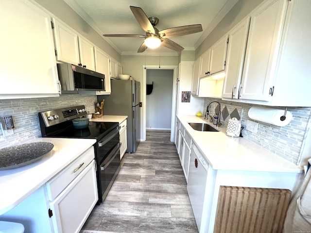 270 Heritage Vlg Unit D, Southbury, CT 06488 - kitchen featuring appliances with stainless steel finishes, white cabinetry, light countertops, backsplash, and crown molding