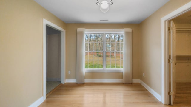 unfurnished dining area with visible vents, baseboards, and light wood-type flooring