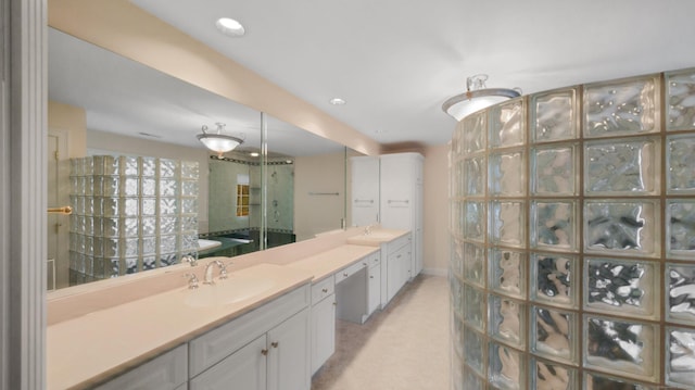 bathroom with a shower, vanity, and recessed lighting