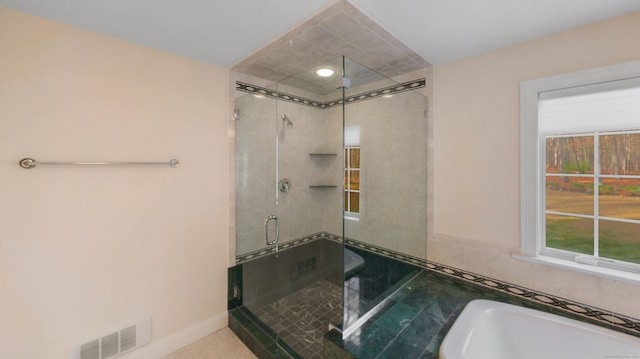 full bathroom featuring visible vents, a shower stall, and a washtub