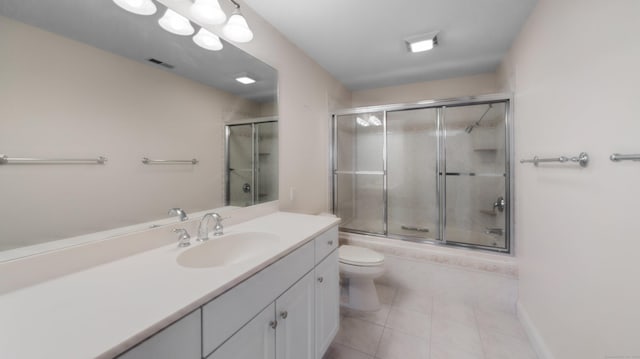 bathroom featuring vanity, bath / shower combo with glass door, tile patterned floors, toilet, and visible vents