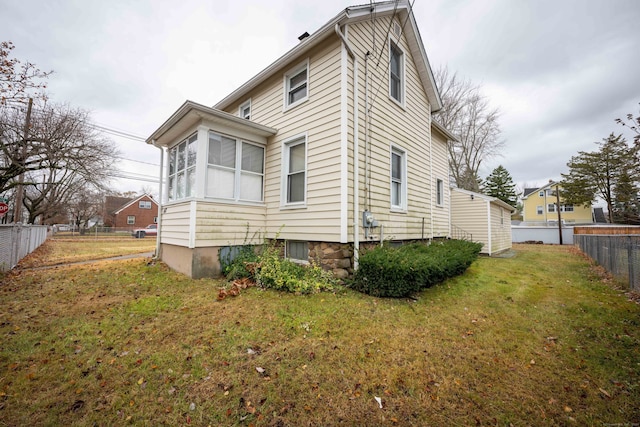 view of property exterior featuring a lawn