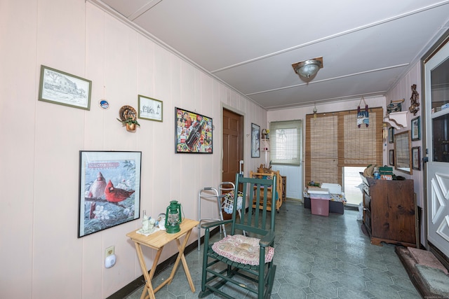 office space with crown molding and wooden walls