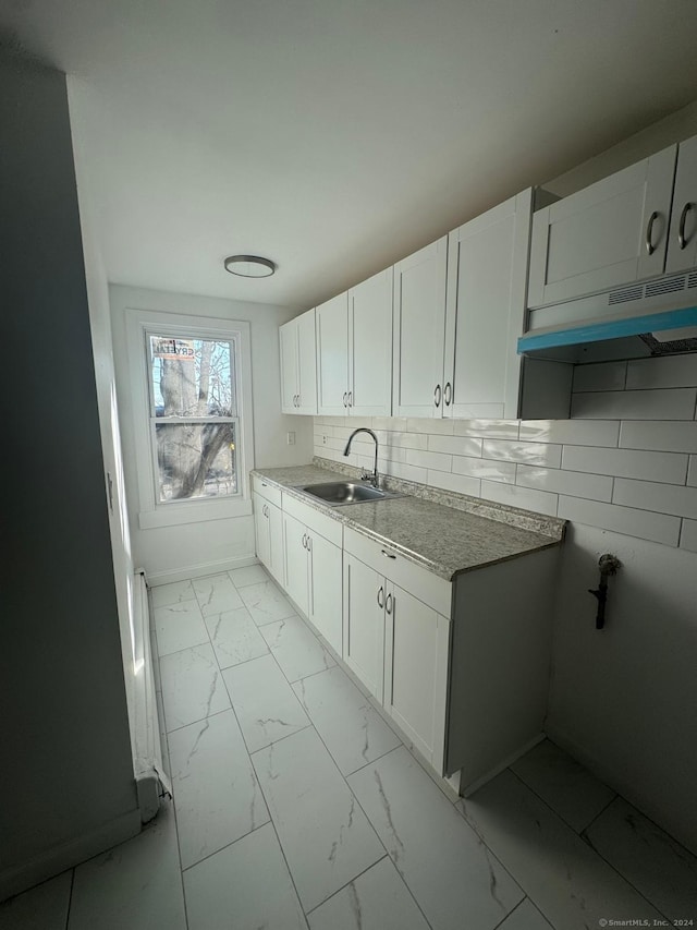 980 Pembroke St, Bridgeport, CT 06608 - kitchen featuring white cabinetry, sink, and tasteful backsplash