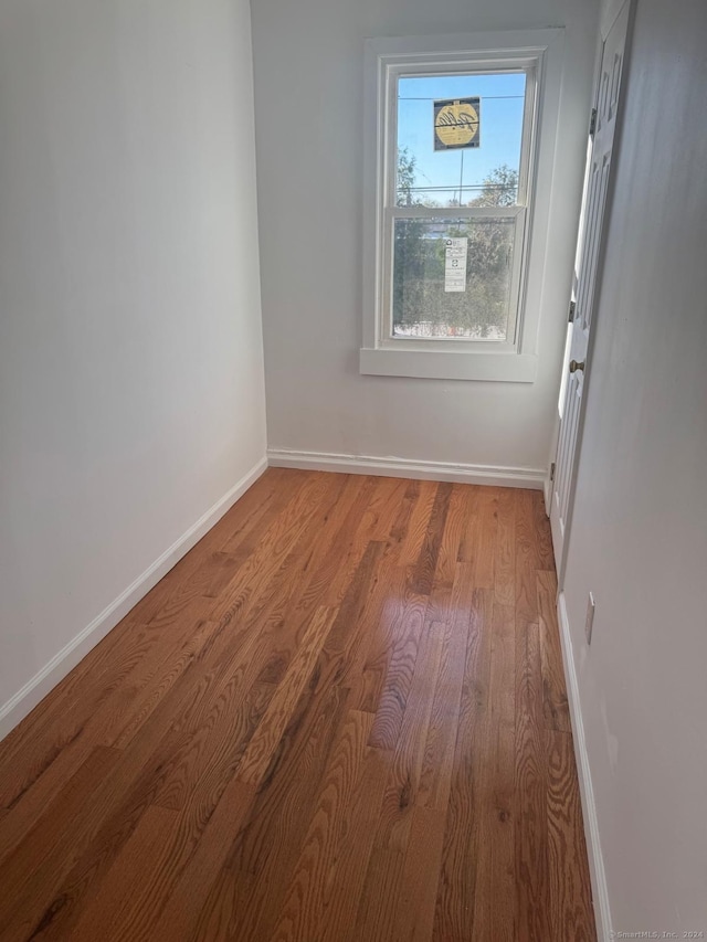 unfurnished room with hardwood / wood-style floors