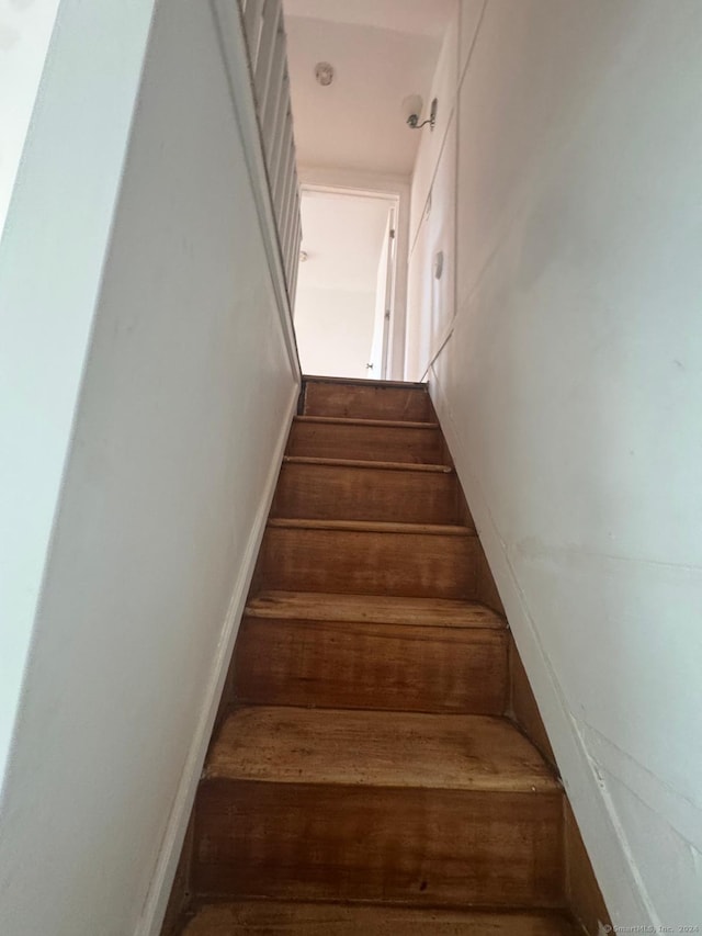 stairway featuring hardwood / wood-style flooring