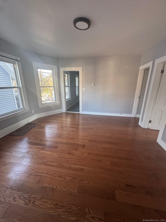 spare room with dark hardwood / wood-style floors