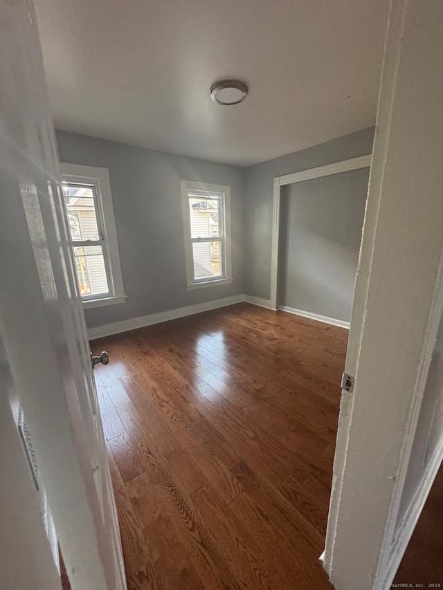 unfurnished bedroom with dark hardwood / wood-style floors