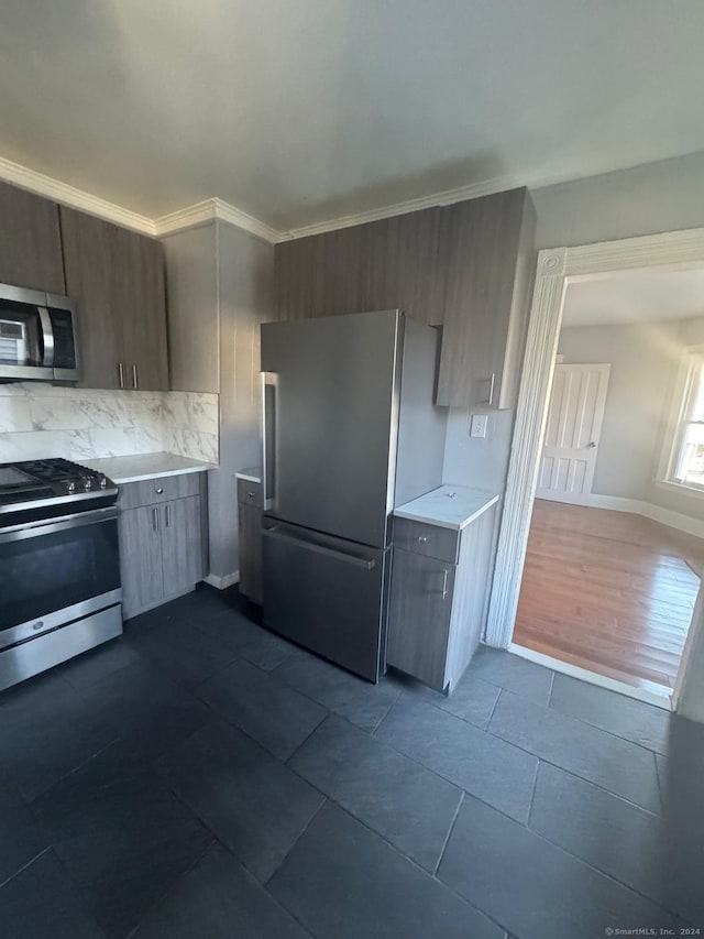 kitchen with tasteful backsplash, dark hardwood / wood-style flooring, ornamental molding, and appliances with stainless steel finishes