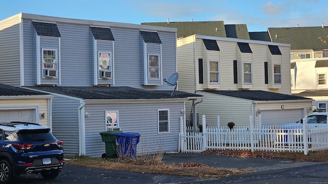 exterior space featuring a garage and cooling unit