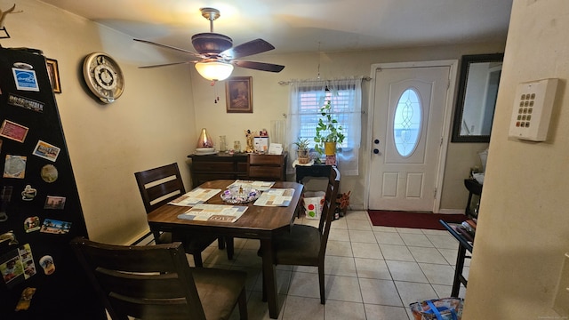 tiled dining room featuring ceiling fan