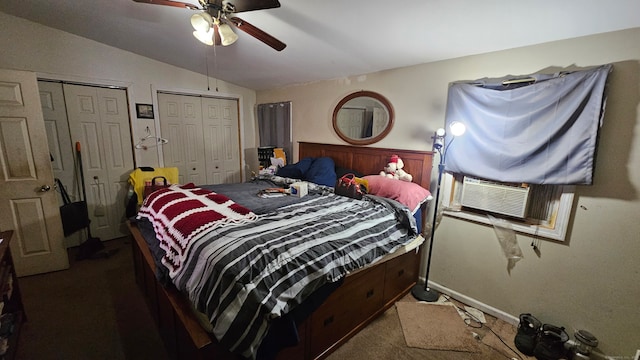 carpeted bedroom with two closets, ceiling fan, and vaulted ceiling