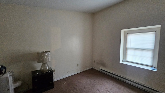 carpeted spare room featuring a baseboard radiator