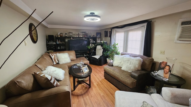 living room with wood-type flooring and an AC wall unit