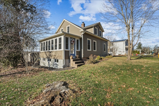 exterior space featuring a lawn and a sunroom