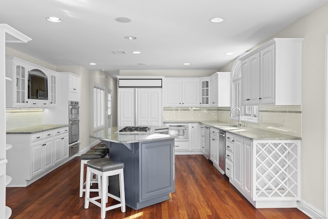 kitchen featuring a center island, dark hardwood / wood-style floors, and white cabinetry