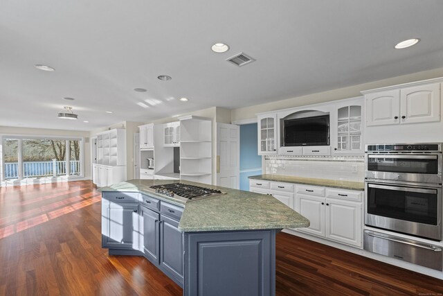 kitchen featuring a center island, dark hardwood / wood-style flooring, white cabinetry, and stainless steel appliances