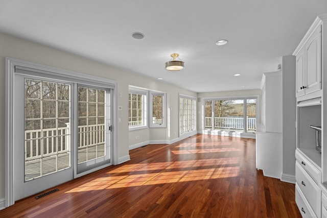 doorway to outside featuring dark wood-type flooring