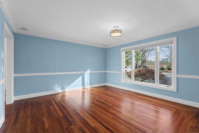 spare room with dark hardwood / wood-style floors and crown molding