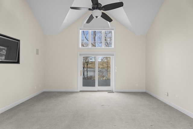 carpeted empty room with vaulted ceiling and ceiling fan