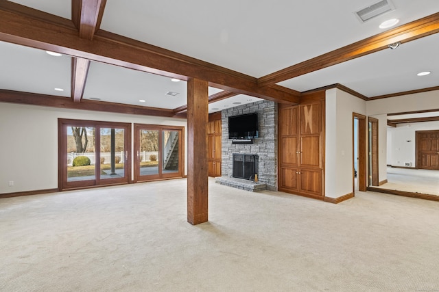 unfurnished living room featuring beam ceiling, coffered ceiling, a fireplace, ornamental molding, and light colored carpet