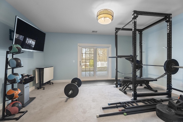 exercise room featuring light colored carpet