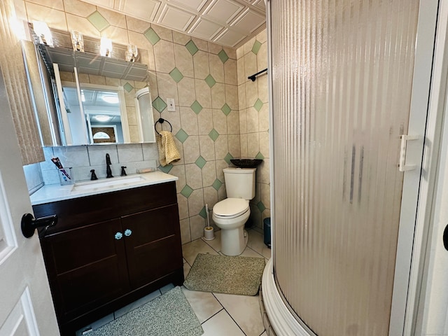 bathroom with tile patterned flooring, an enclosed shower, decorative backsplash, vanity, and tile walls