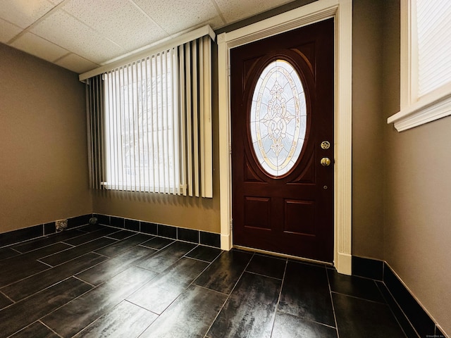 foyer featuring a drop ceiling and dark wood-type flooring