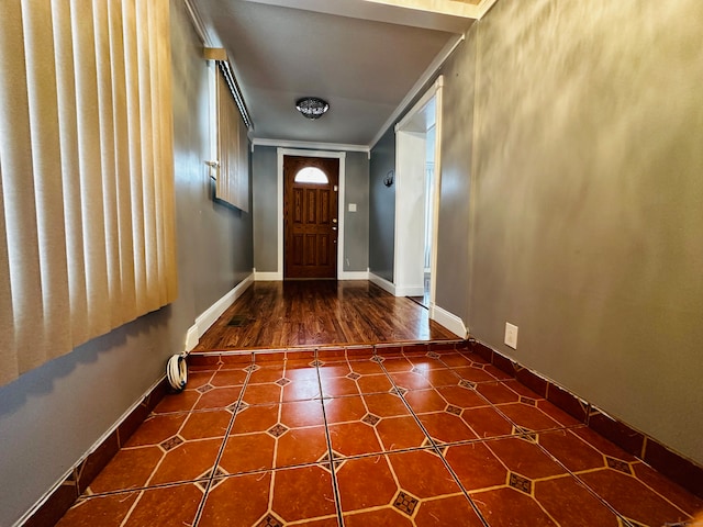 doorway with crown molding and dark hardwood / wood-style flooring