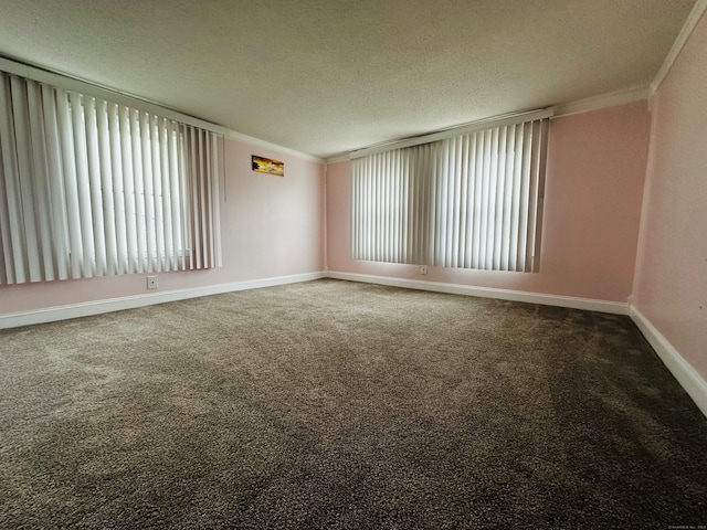 carpeted empty room featuring a textured ceiling and crown molding