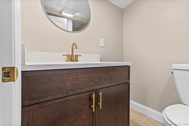 bathroom with toilet, tile patterned floors, and vanity