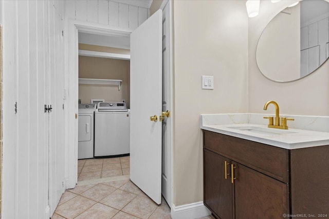 bathroom featuring vanity, washer and dryer, and tile patterned flooring