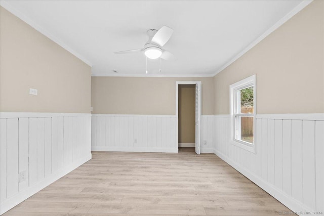 empty room with light hardwood / wood-style floors, ceiling fan, and ornamental molding