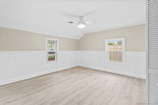 empty room featuring ceiling fan, plenty of natural light, and light hardwood / wood-style flooring