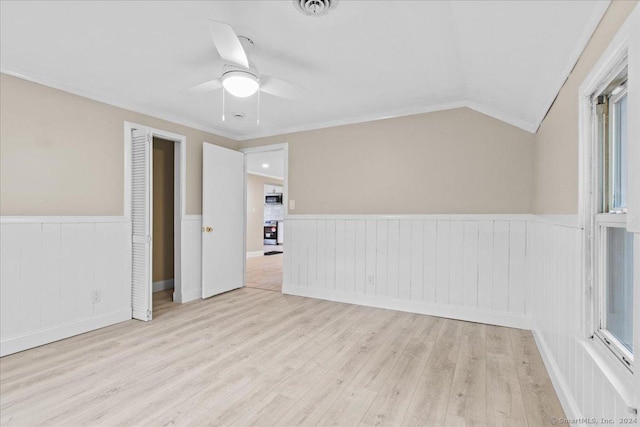 spare room featuring crown molding, light hardwood / wood-style flooring, lofted ceiling, and ceiling fan