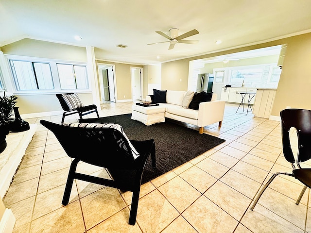 tiled living room with ceiling fan and ornamental molding