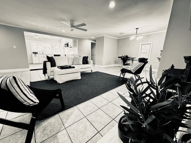 tiled living room featuring sink, ceiling fan with notable chandelier, and crown molding