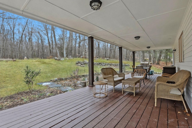 wooden deck with a lawn