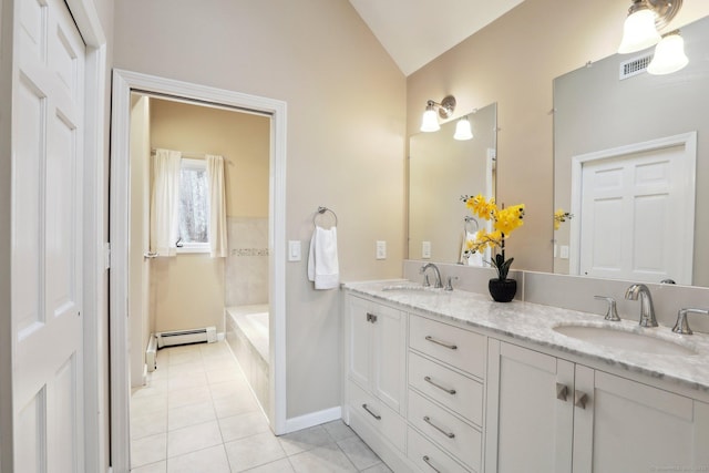 bathroom with lofted ceiling, vanity, tiled tub, tile patterned flooring, and a baseboard heating unit