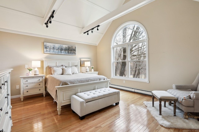 bedroom with light hardwood / wood-style floors, lofted ceiling with beams, rail lighting, and baseboard heating