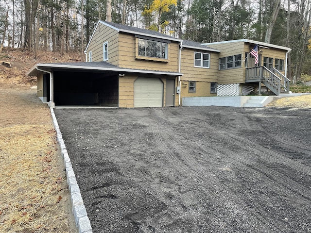 view of side of home with a carport and a garage