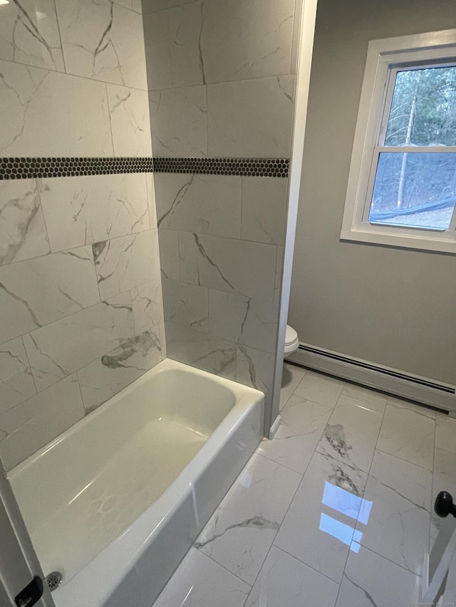 bathroom with a baseboard heating unit, toilet, and tiled shower / bath combo